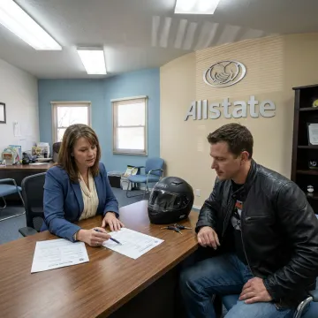 Agent reviewing motorcycle insurance with rider