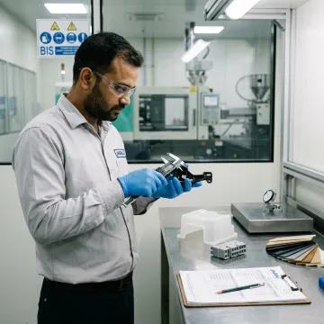 Engineer inspecting moulded plastic parts