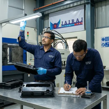 Engineers inspecting hybrid vehicle plastic components