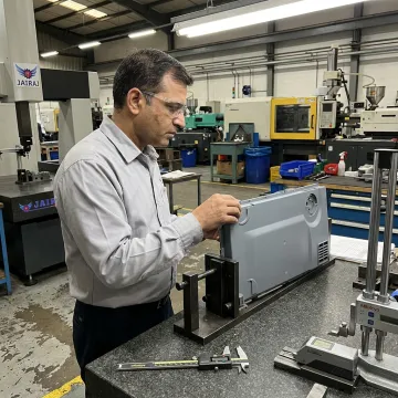 Engineer inspecting appliance plastic parts