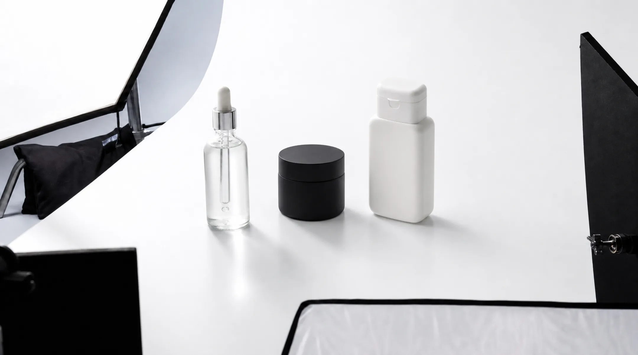 Reflective transparent and matte products photographed on white background