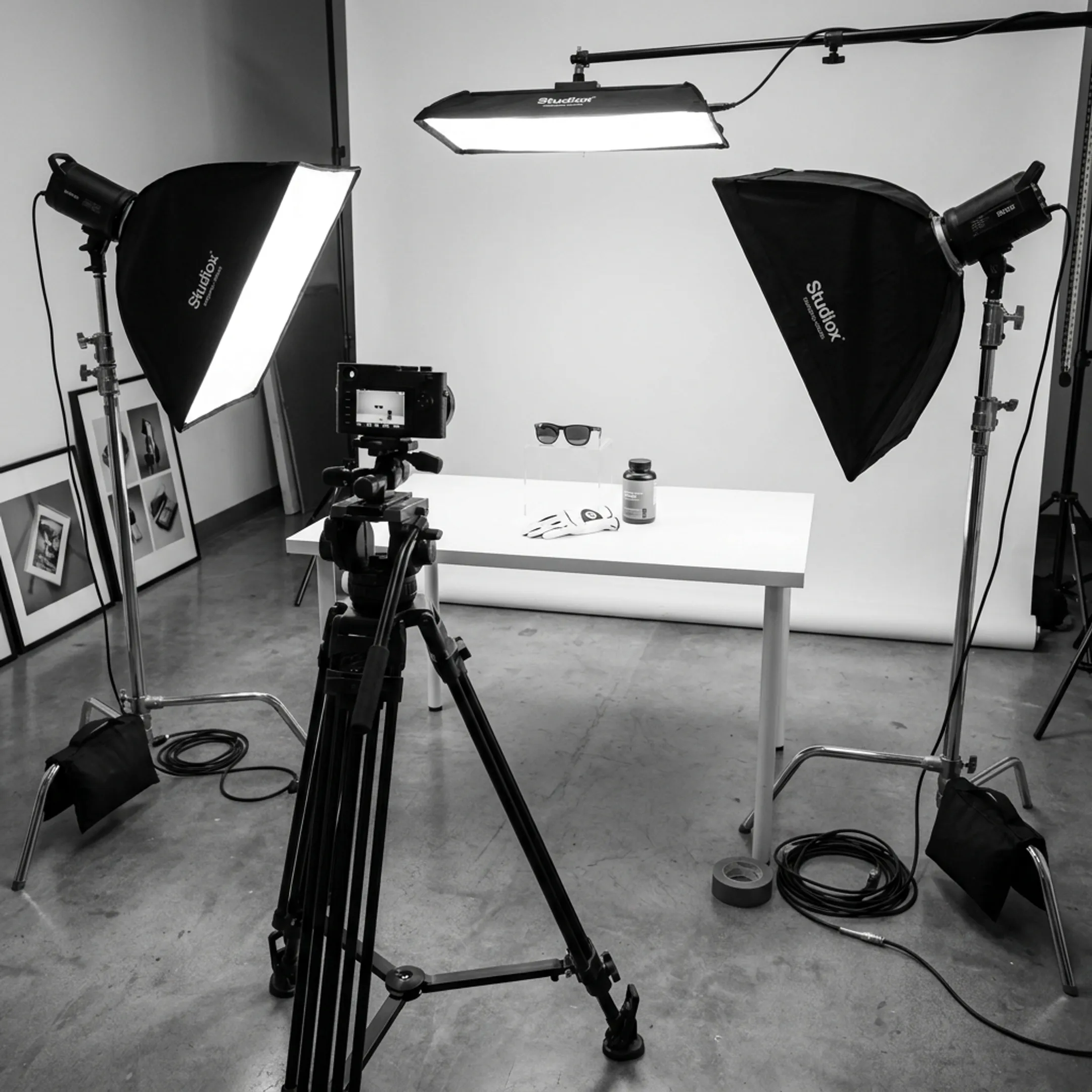 Commercial photographer setting up lighting for a studio product shoot