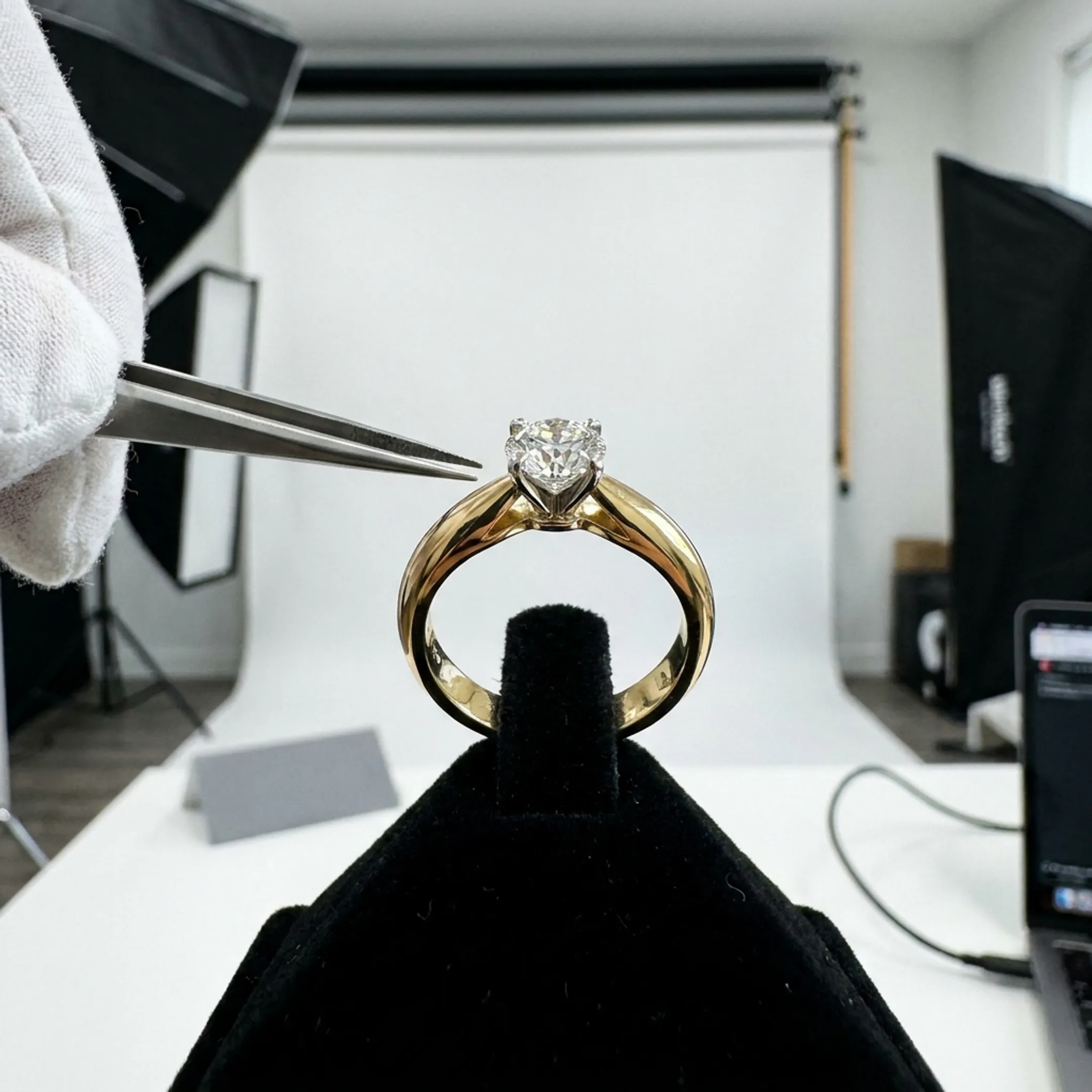 Close-up studio photography setup showing a gold gemstone ring under macro studio lighting.