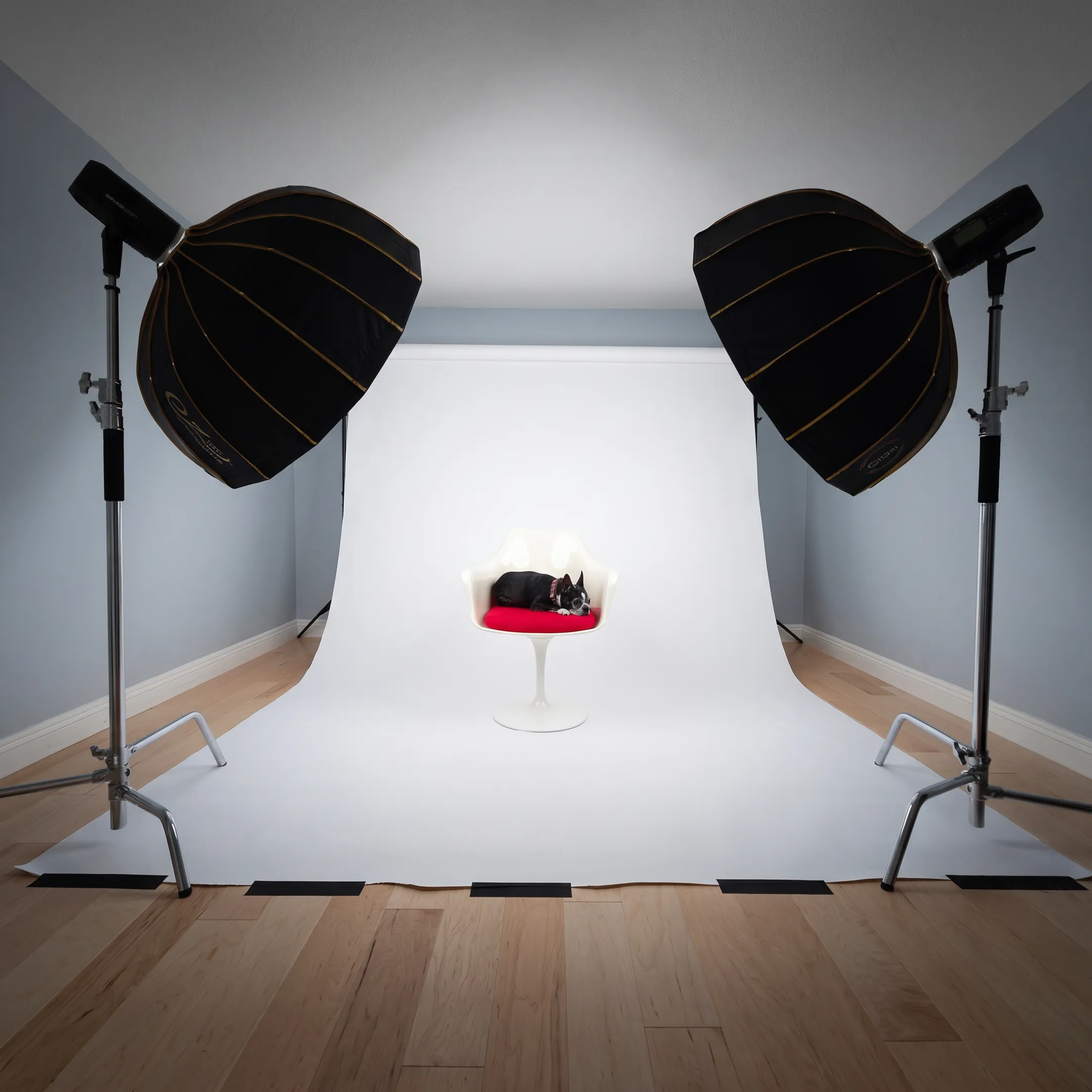 Commercial photographer directing product lighting on studio tabletop