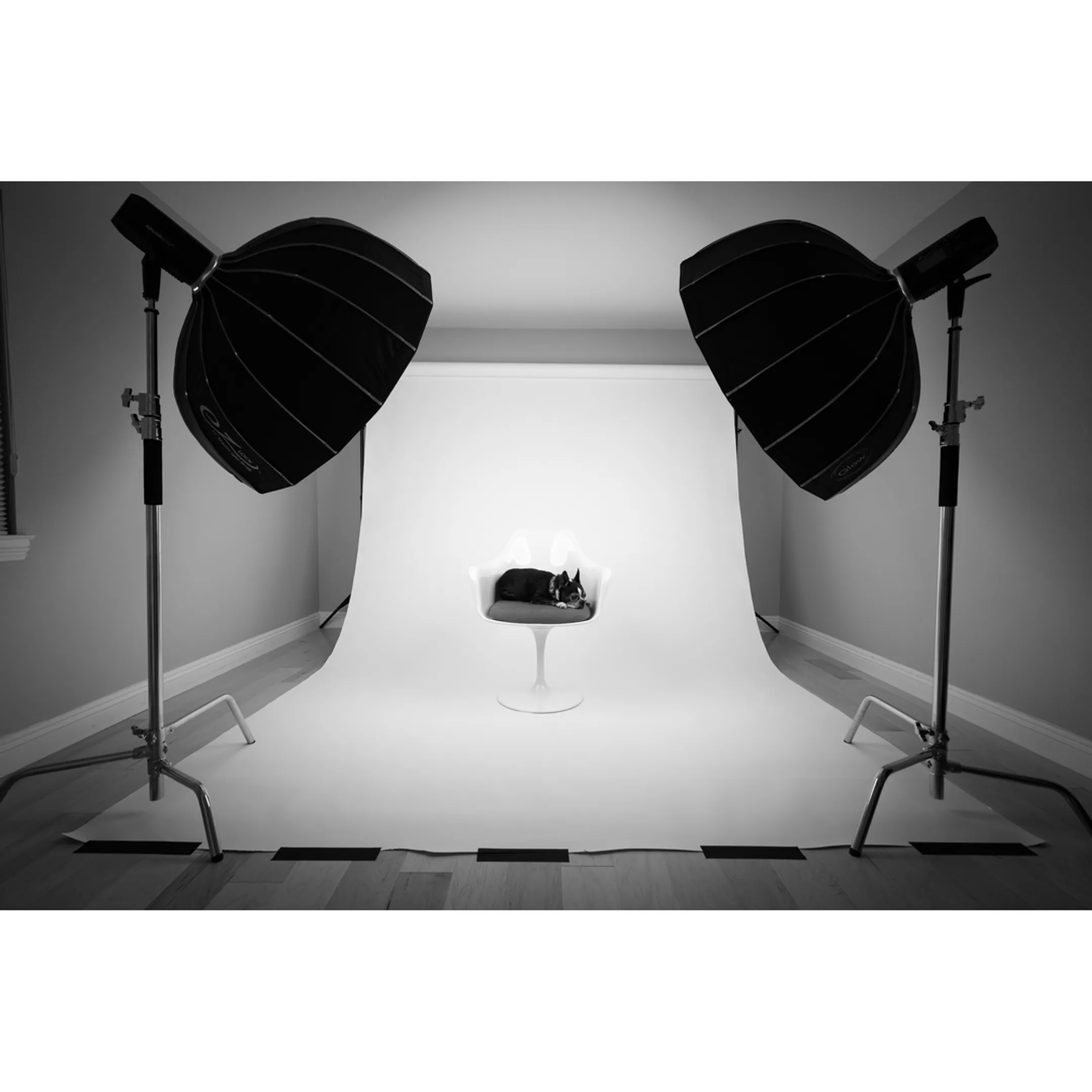 Commercial photographer inspecting product lighting on a studio staging table