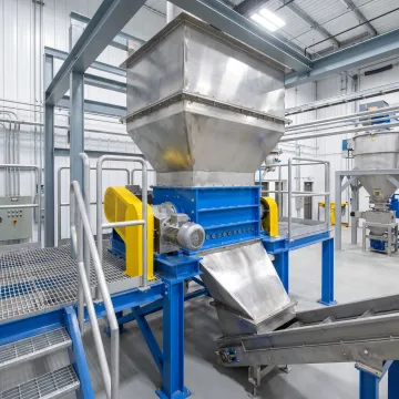 Industrial crushing and pulverizing equipment in a manufacturing facility