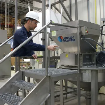 Engineer reviewing powder processing equipment design