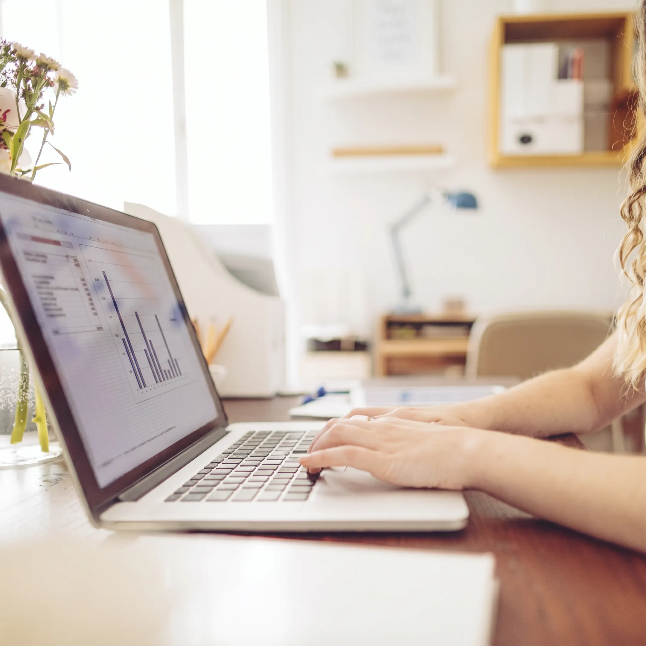Bookkeeper reviewing organized QuickBooks records on a computer