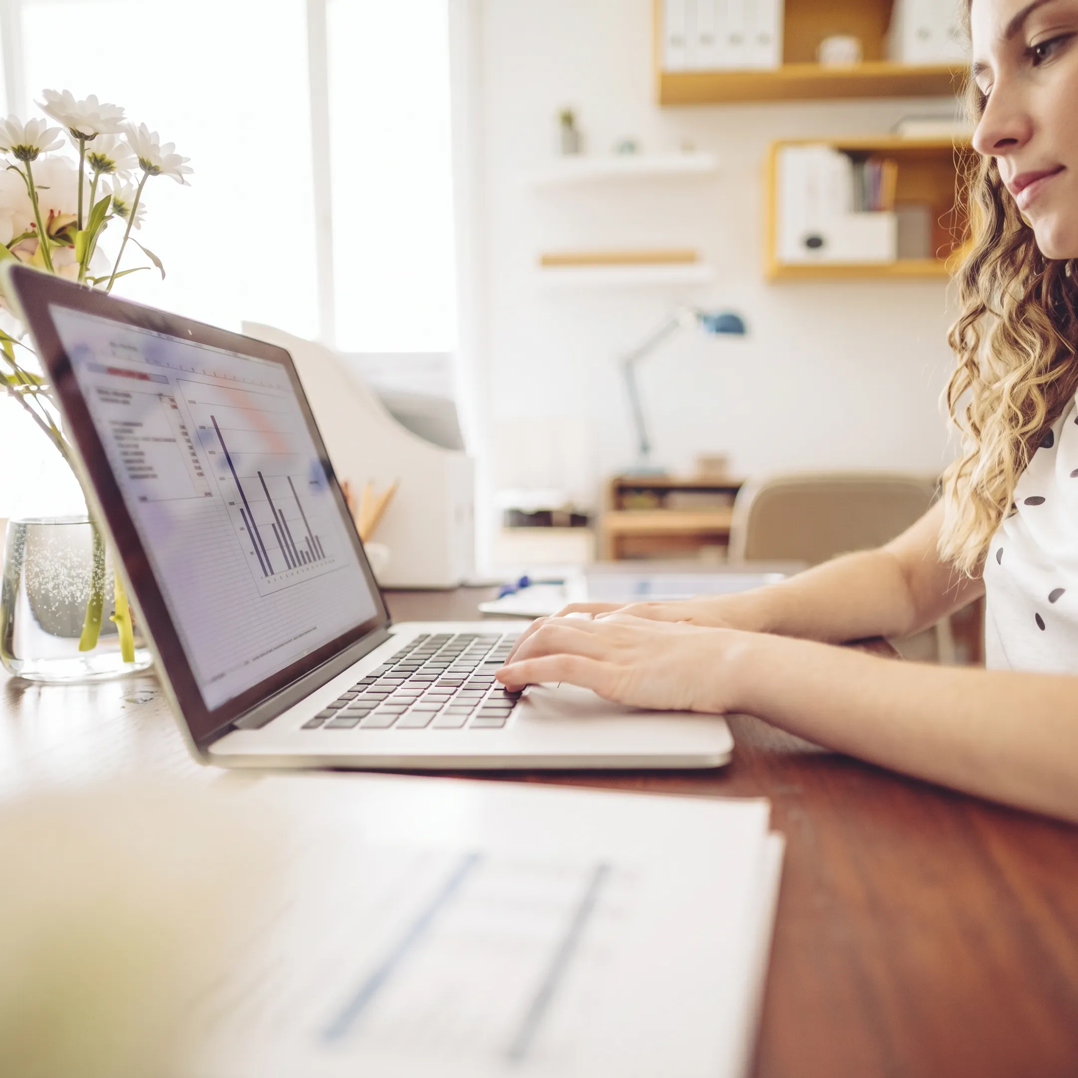 Professional reviewing cleaned-up bookkeeping records on a laptop
