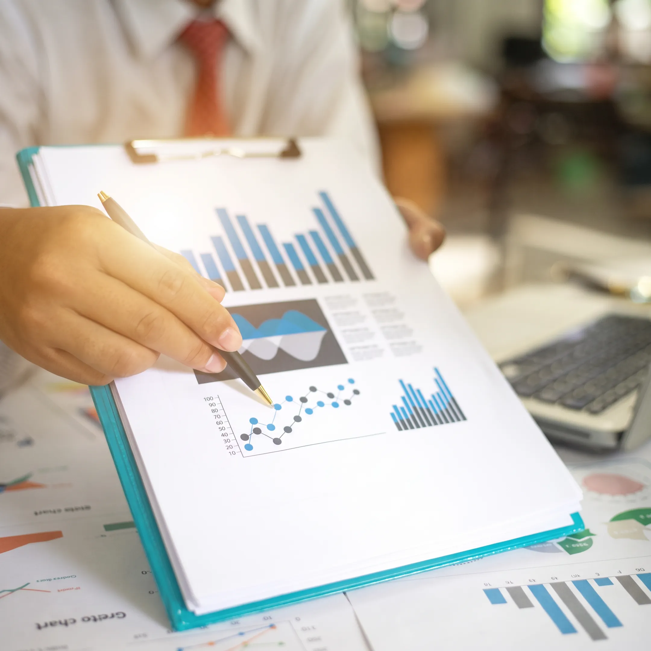 Tax professional reviewing composite return documents with business owner