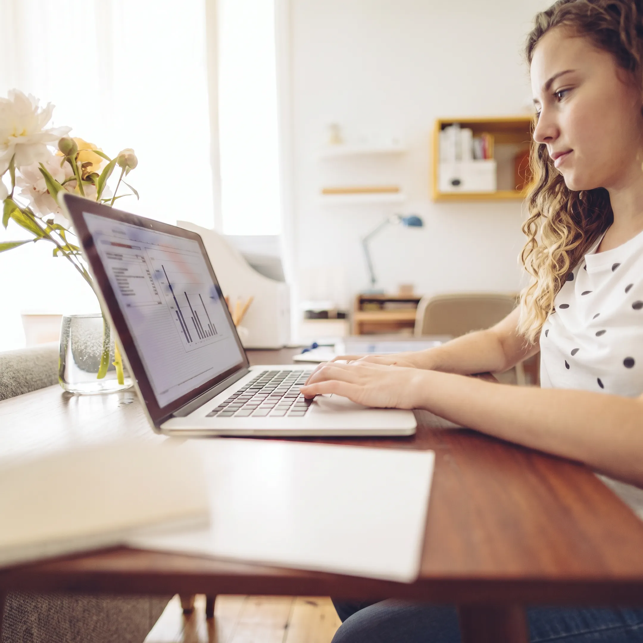 Bookkeeper organizing business financial records and reviewing accounting software