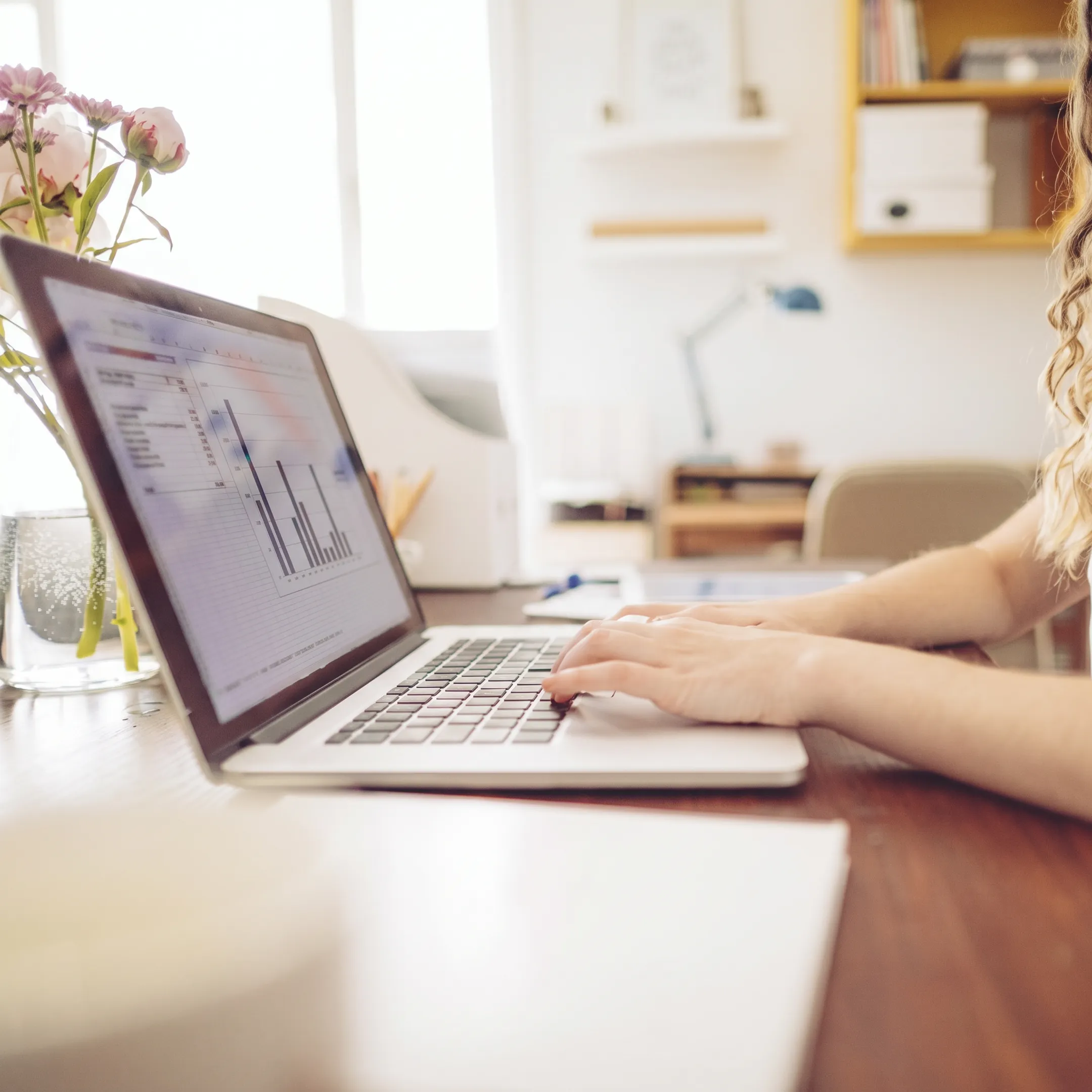Bookkeeping professional analyzing organized financial records on a computer