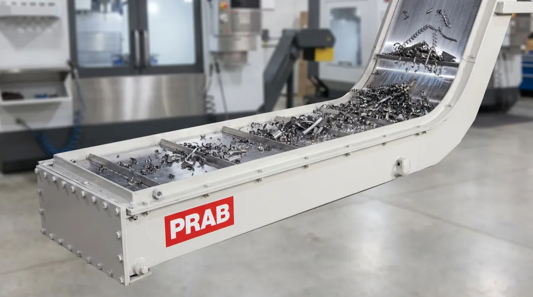 Magnetic conveyor system transporting ferrous metal chips and scrap at incline