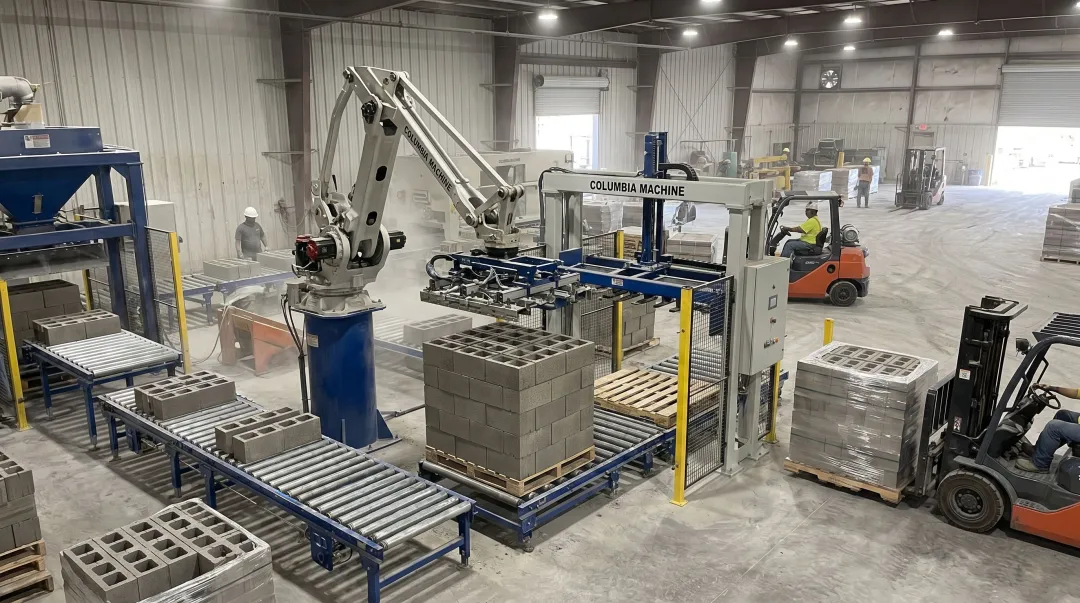 Columbia Machine integrated concrete block cubing and palletizing system on production floor
