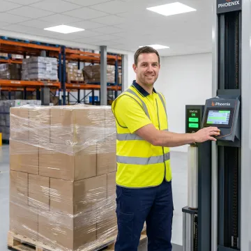 Technician inspecting stretch wrapper equipment