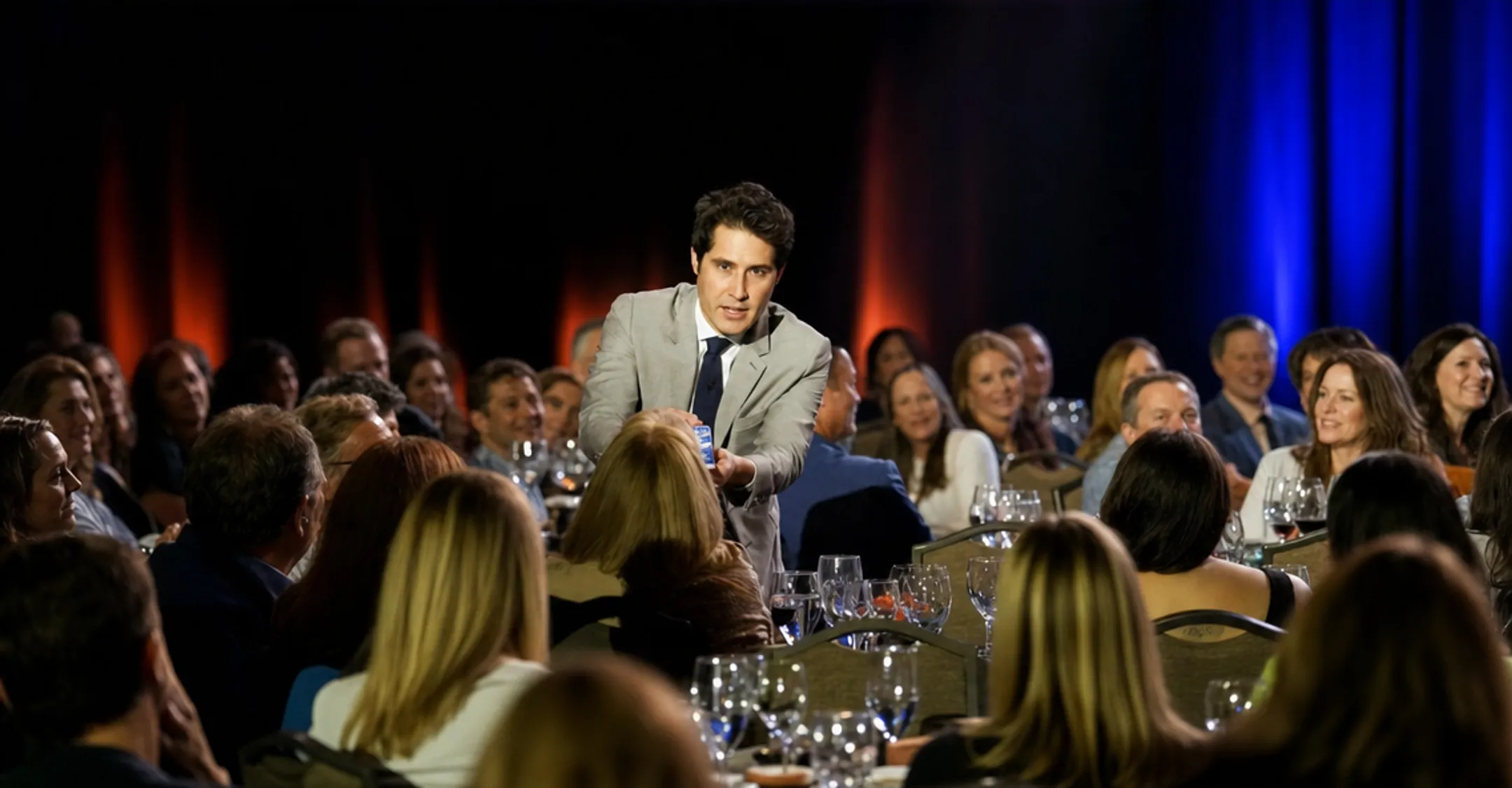 Keynote speaker performing magic trick during corporate conference presentation