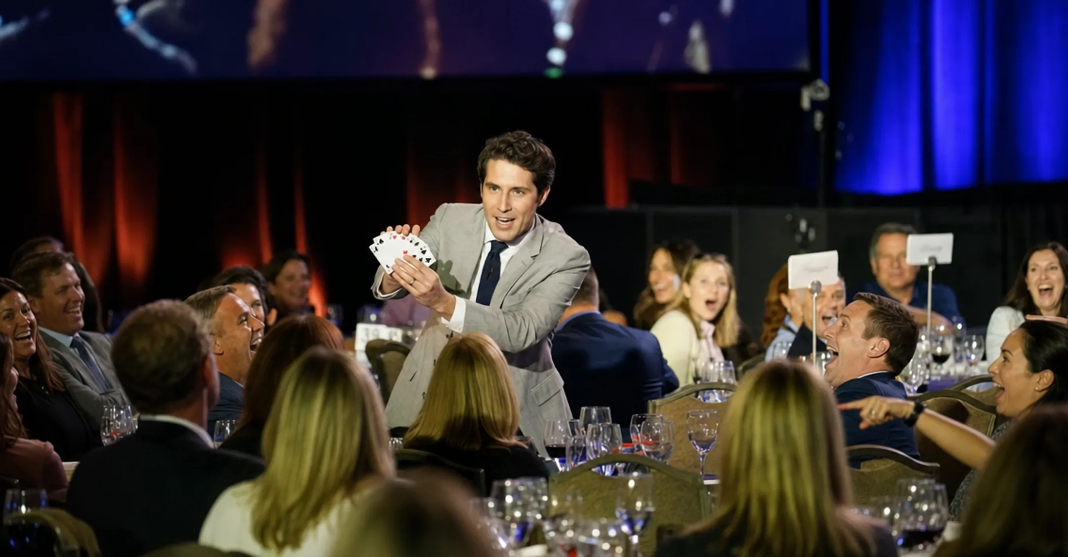 Keynote speaker performing live magic trick for engaged conference audience