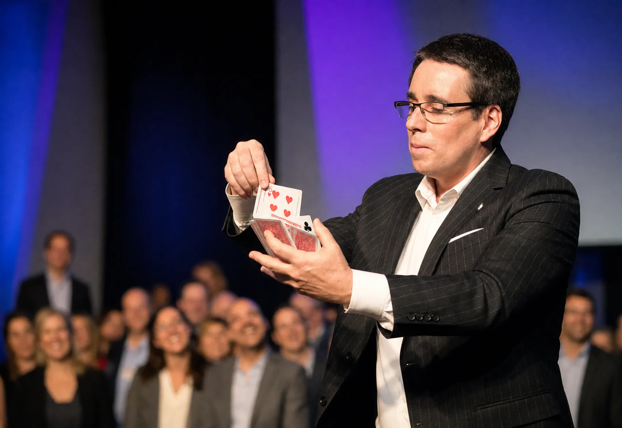 Keynote speaker performing card magic trick during motivational presentation