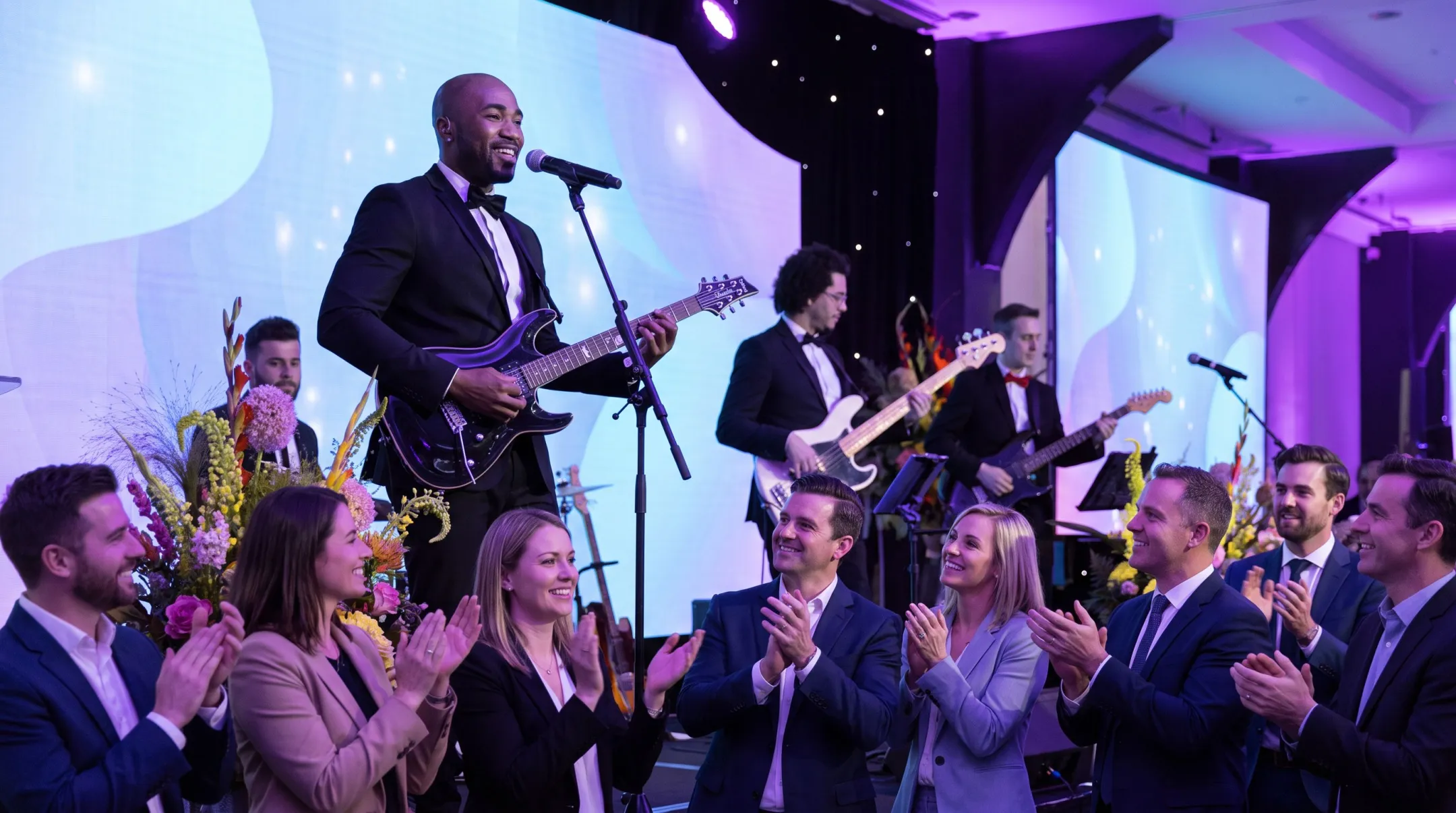 Musician entertainer playing guitar on stage at business conference