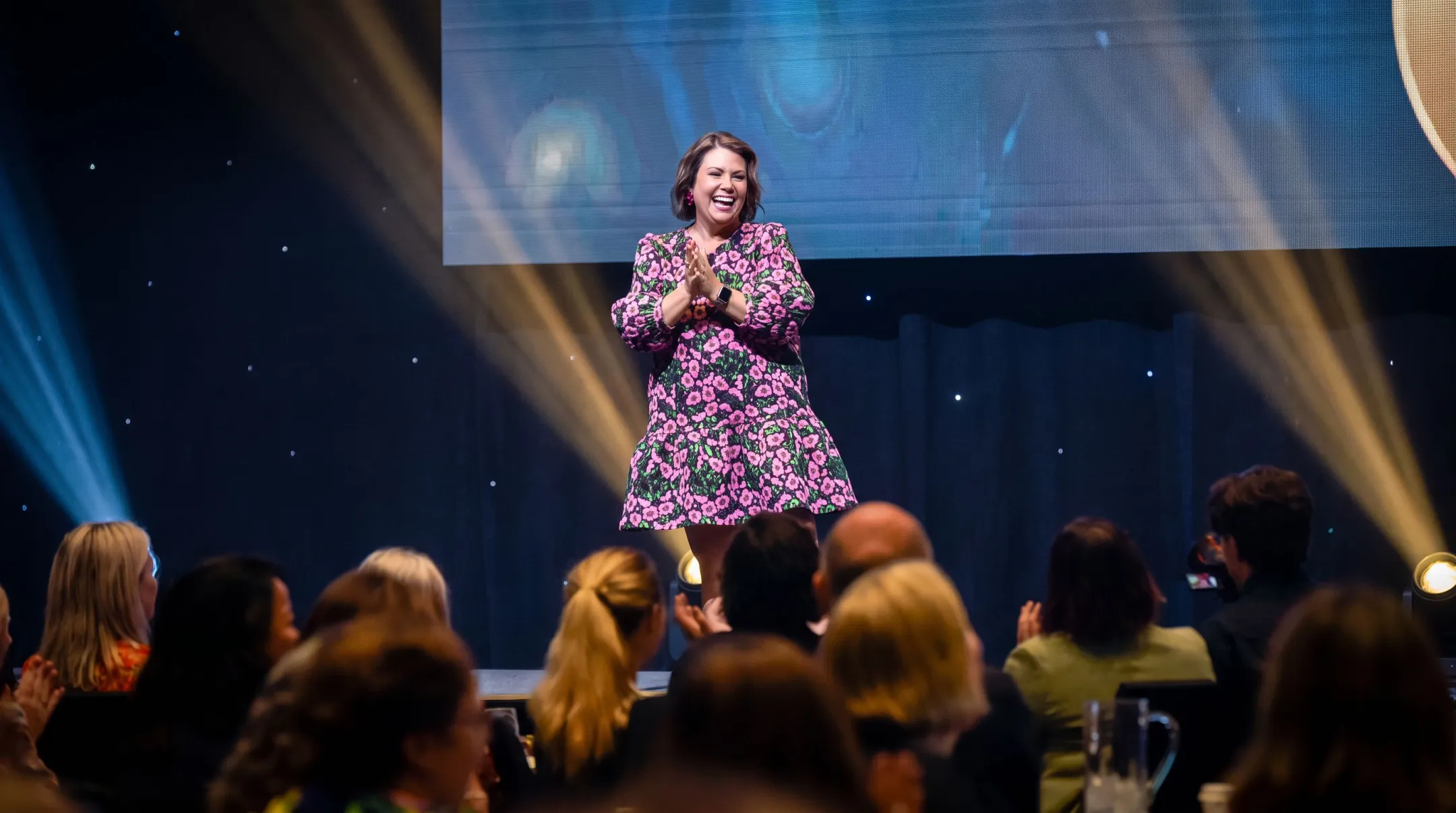 Motivational speaker sharing personal resilience story on stage