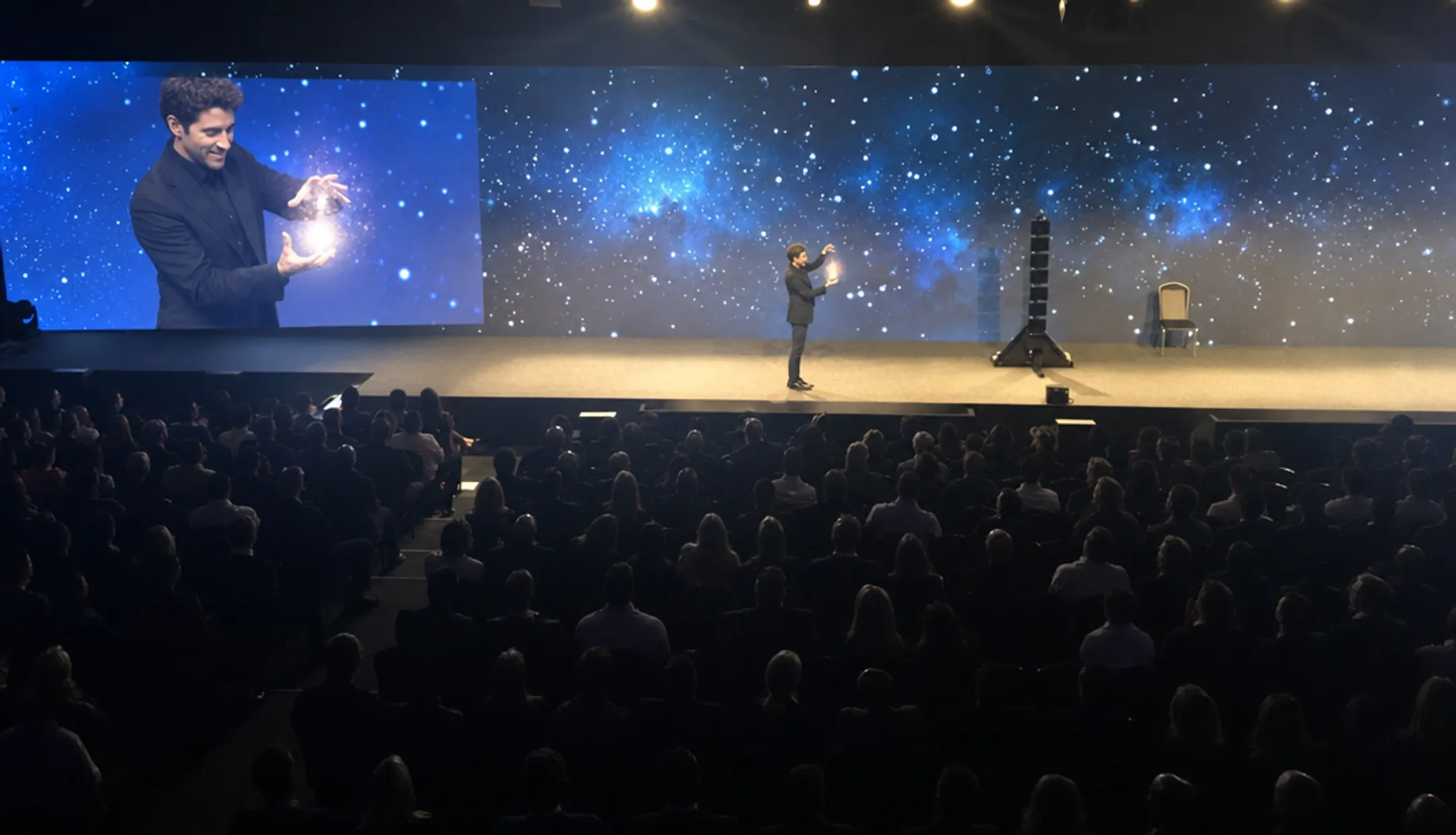 Keynote speaker performing magic trick during corporate leadership presentation