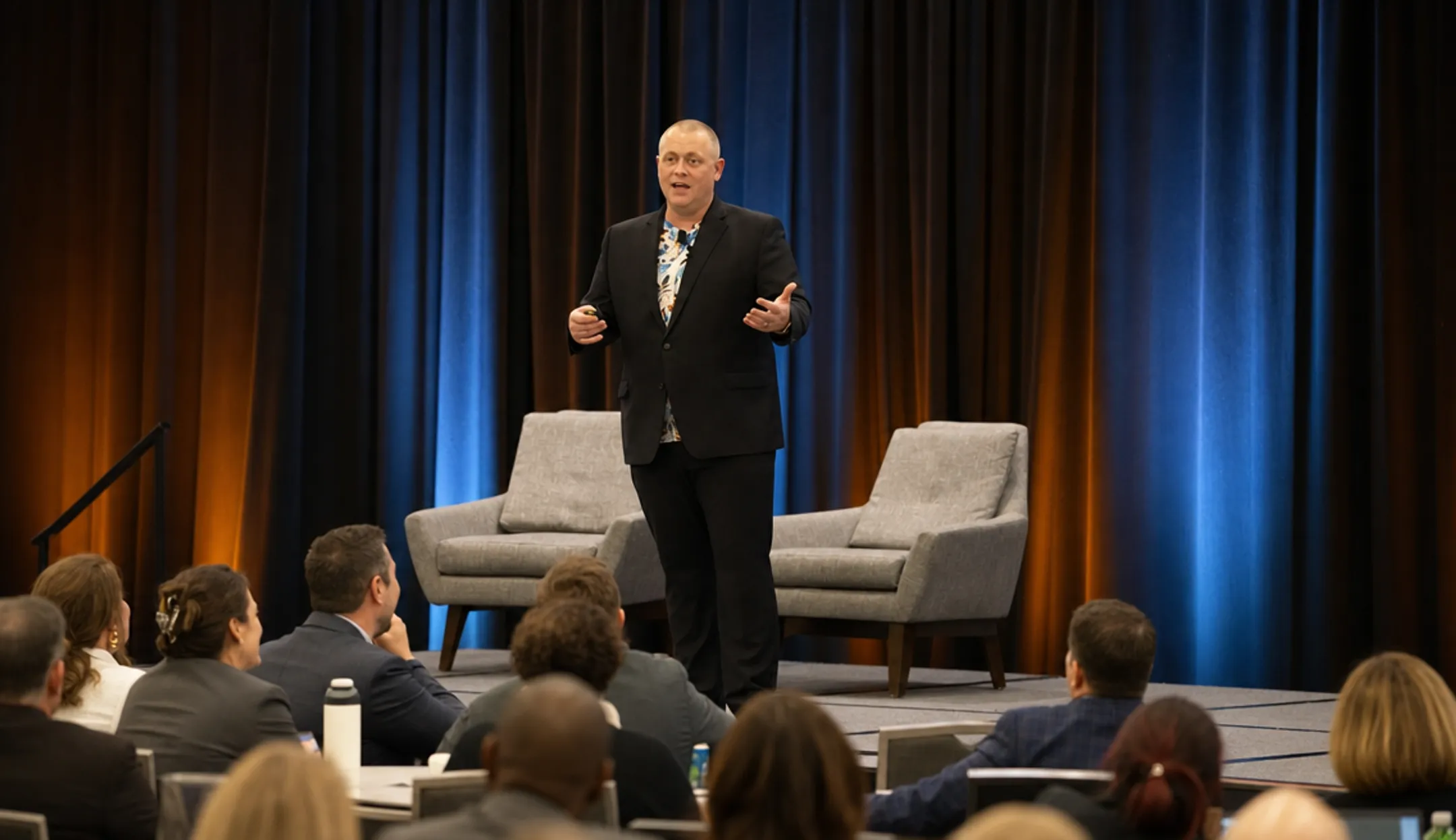 Motivational speaker sharing personal story on stage to corporate audience