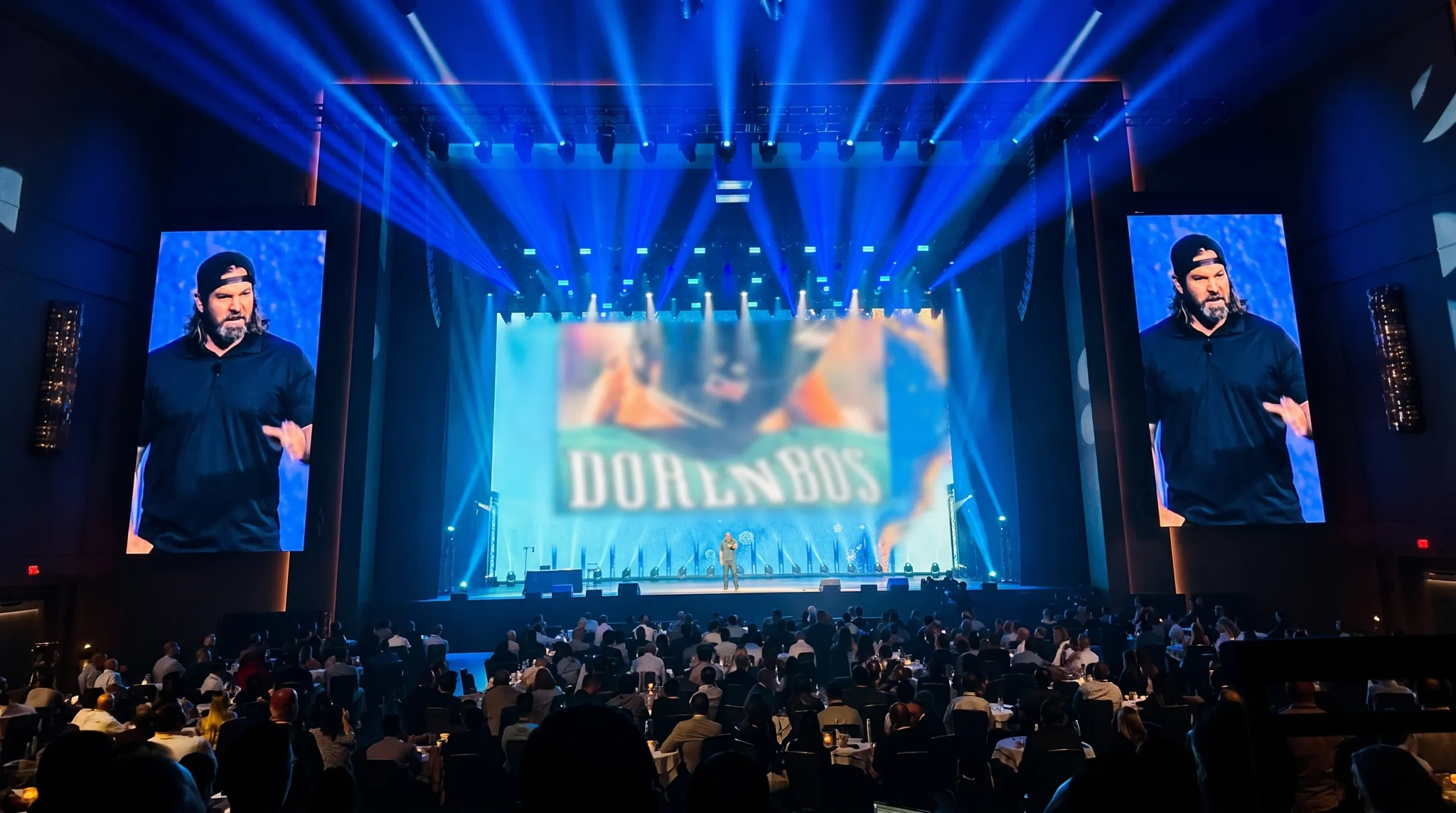 Former NFL long snapper turned motivational speaker on stage
