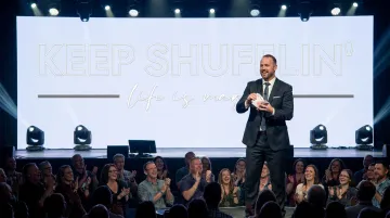 Jon Dorenbos performing card magic during corporate keynote speech on stage
