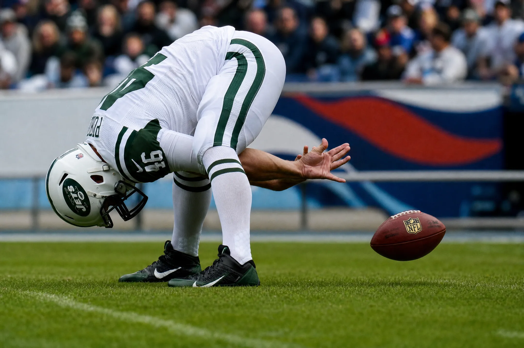 NFL long snapper preparing for snap during professional football game