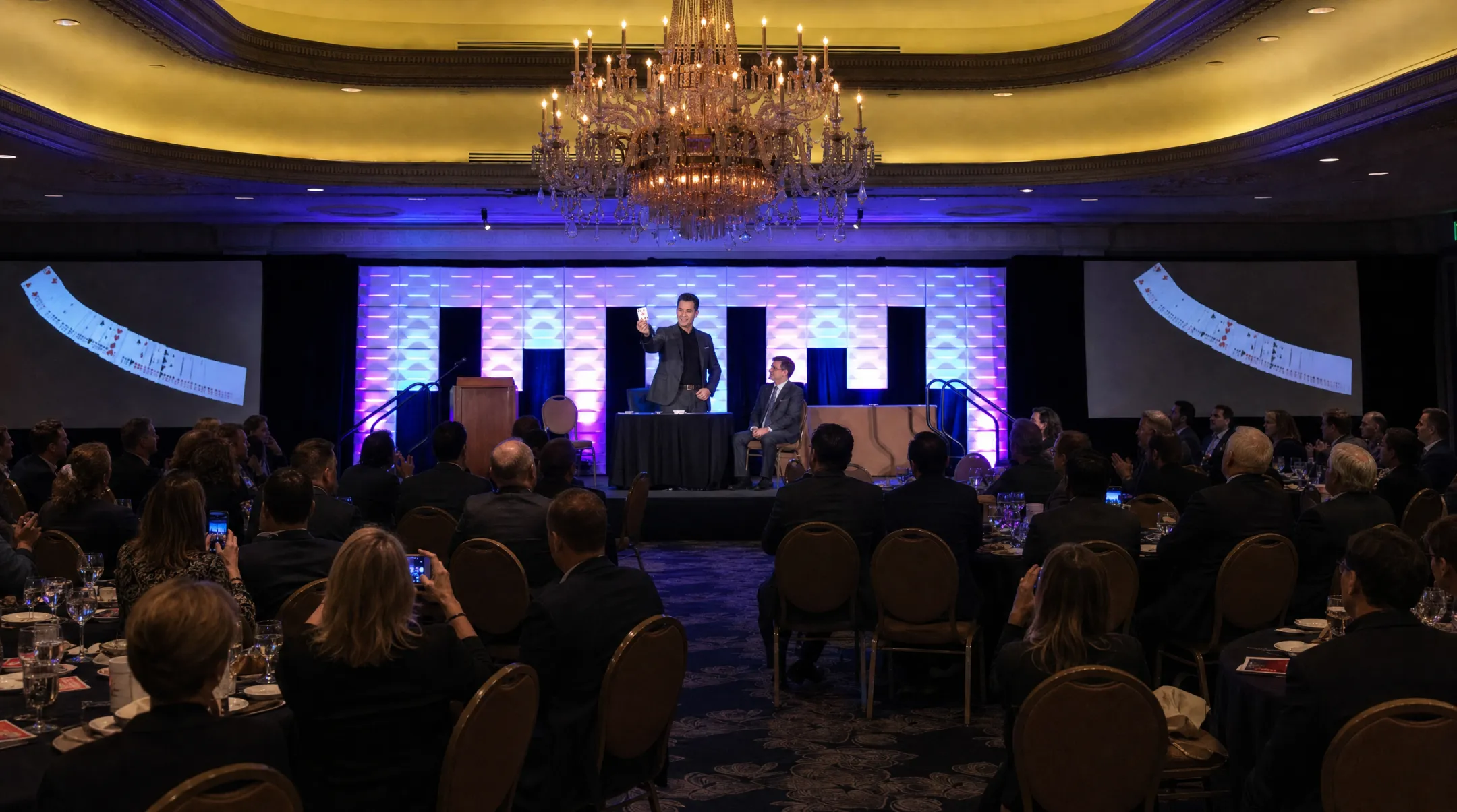 Professional speaker performing interactive magic trick on corporate stage