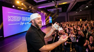 Jon Dorenbos performing signature magic and storytelling keynote on stage