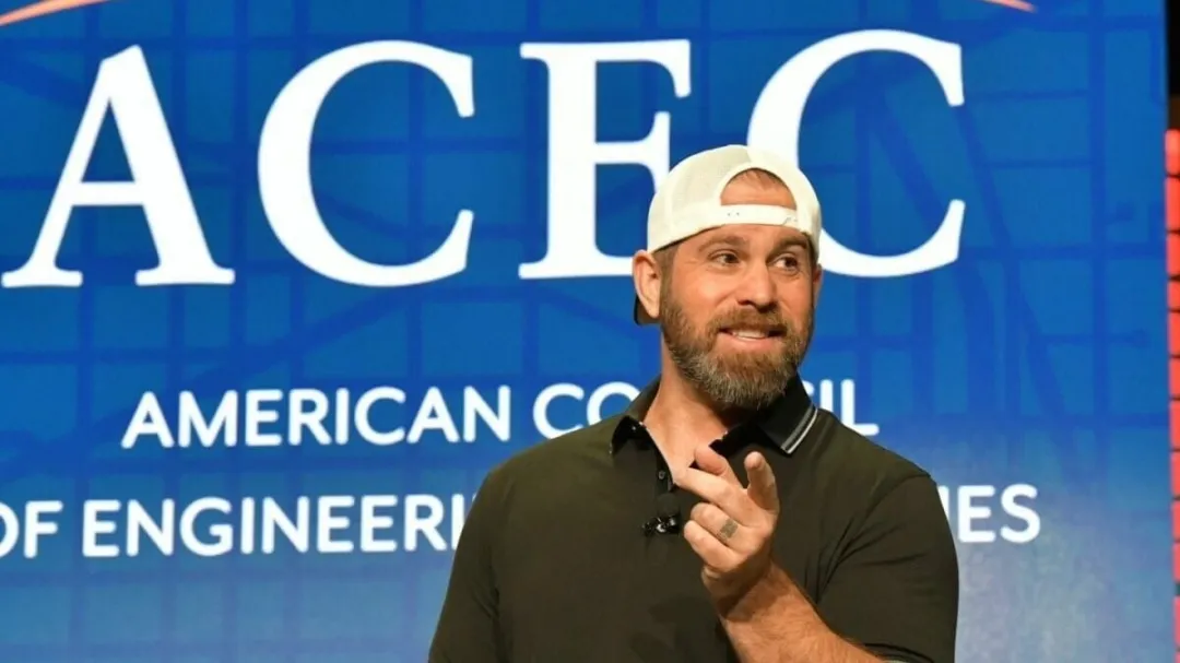 Motivational speaker performing magic illusion during corporate keynote presentation