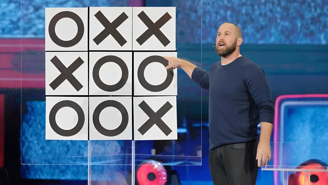 Jon Dorenbos performing sleight-of-hand magic during a corporate keynote presentation