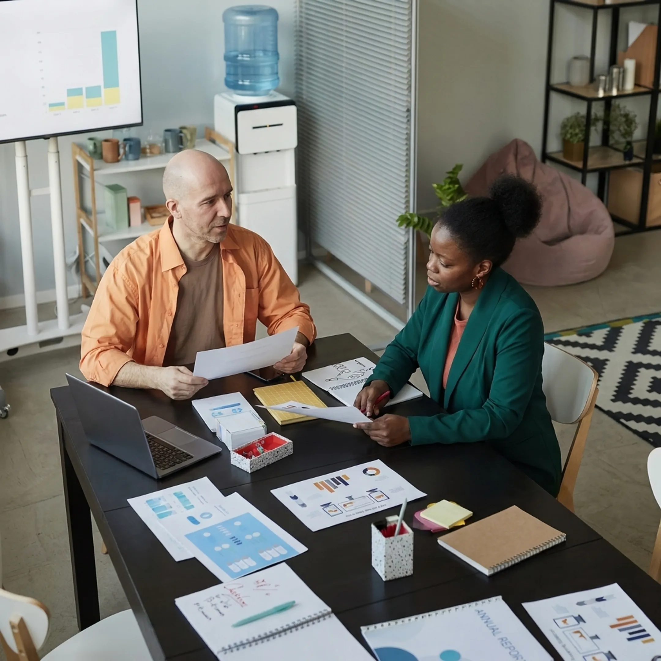 Small business owner reviewing financial reports with an accounting advisor