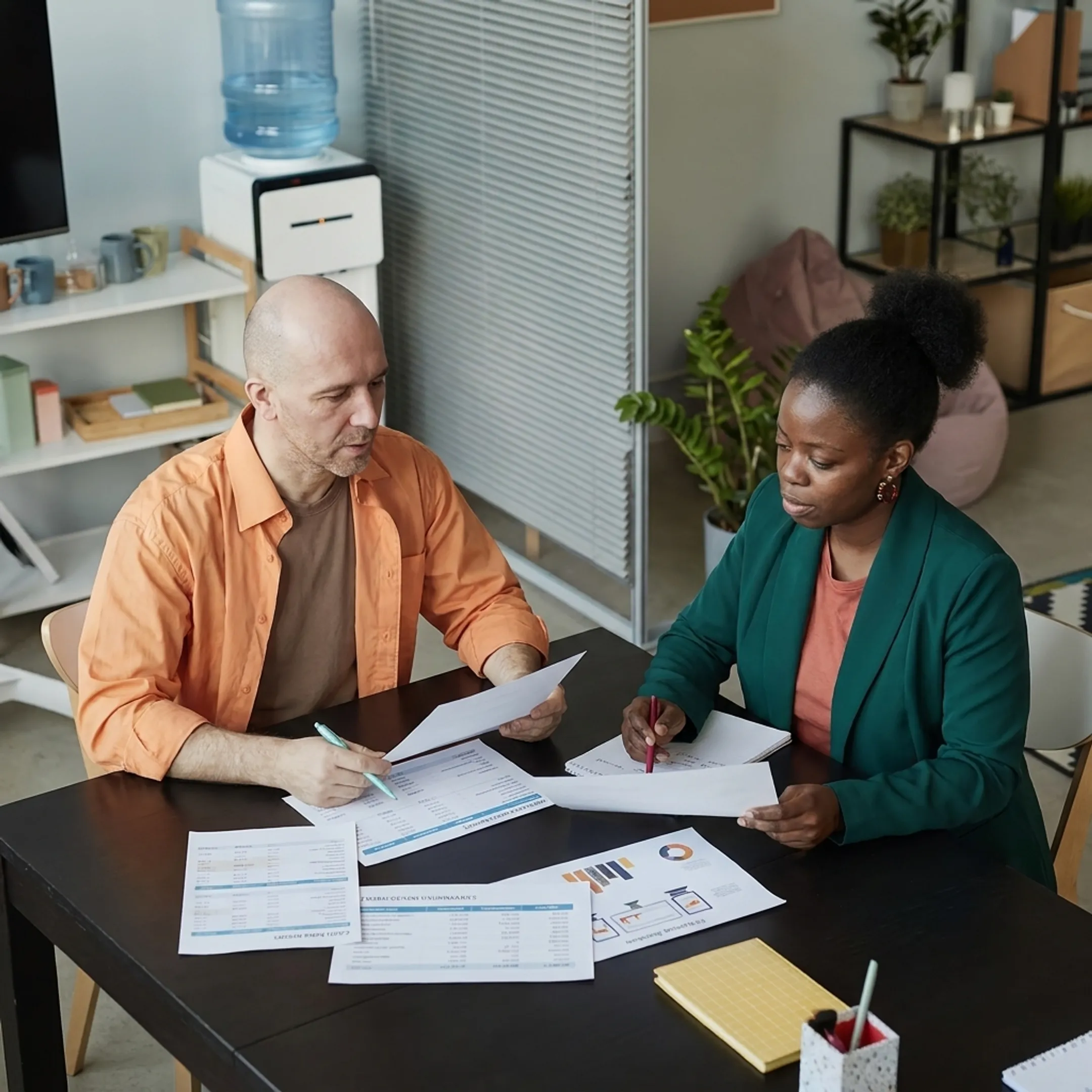 Freelancer reviewing reconciled bookkeeping reports with an accounting professional