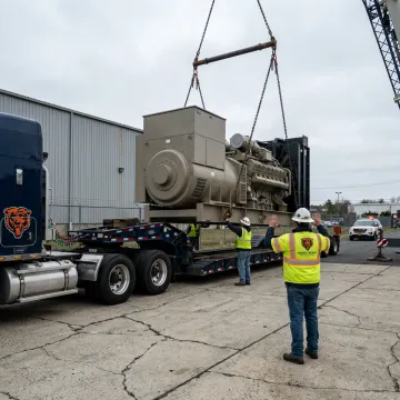 Heavy machinery being loaded onto a specialized trailer