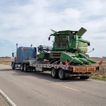 Combine harvester loaded for heavy-haul shipping