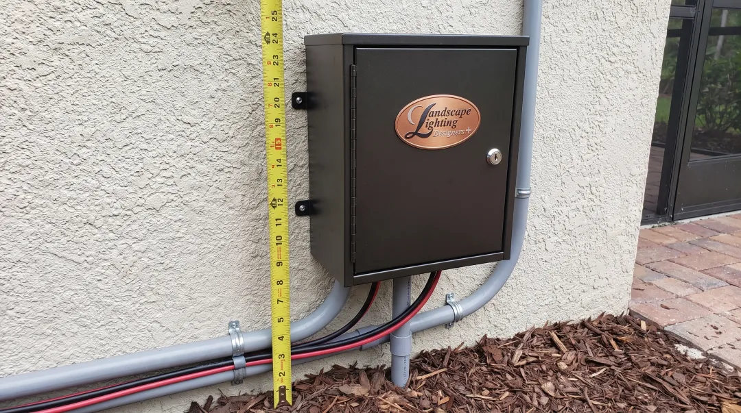 Properly mounted low voltage landscape lighting transformer with secure installation and wire management