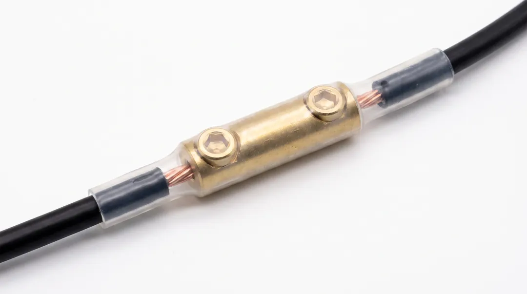 Brass barrel connector with heat-shrink tubing creating weatherproof low voltage wire connection