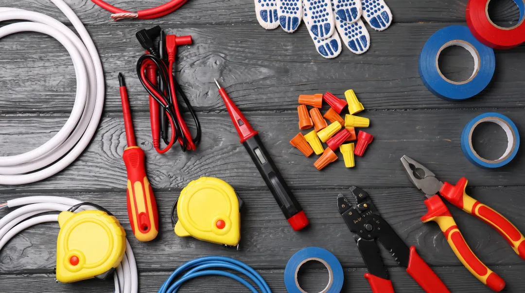 Essential electrical tools including voltage tester wire strippers screwdrivers and safety equipment for installation