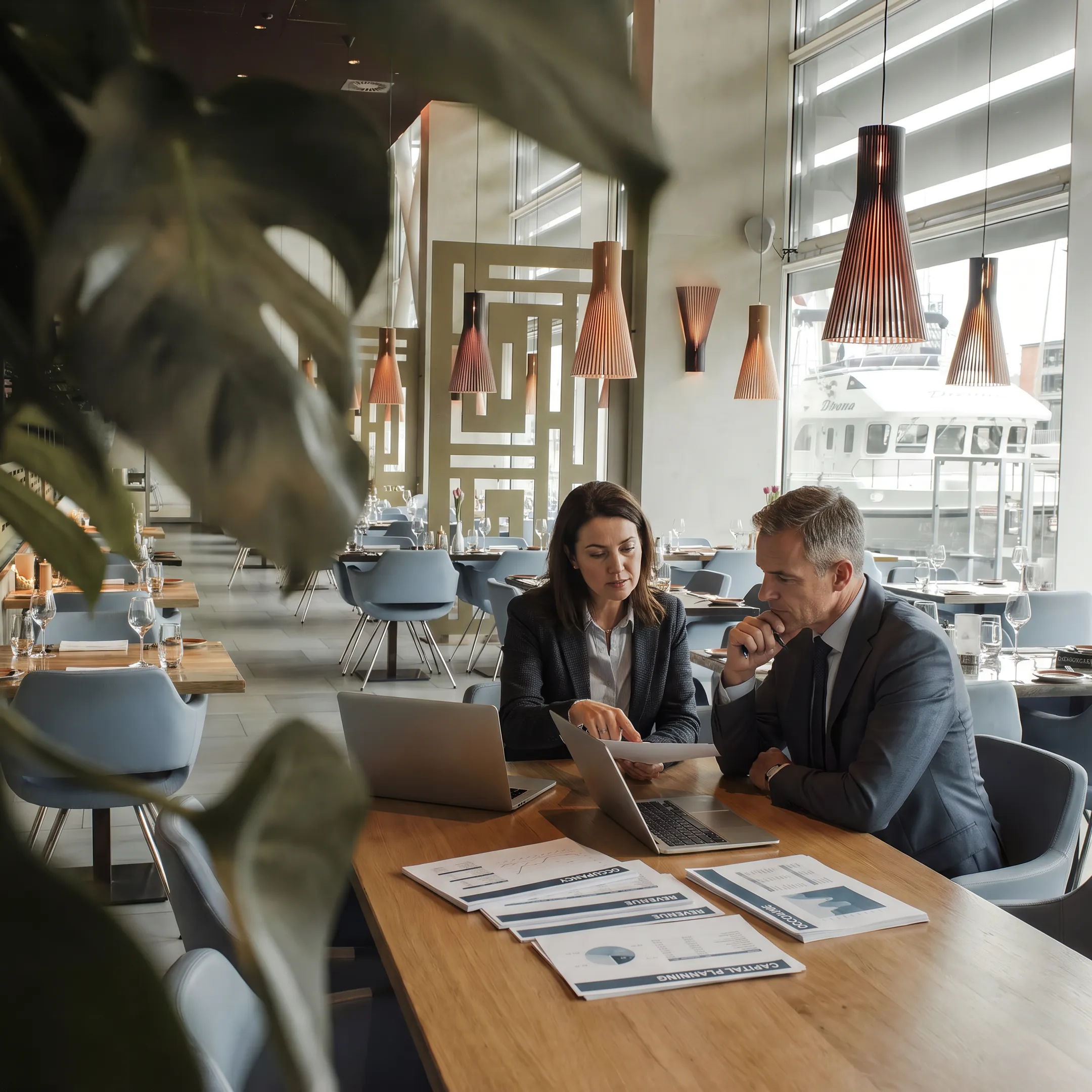 Hotel investor reviewing property performance with asset manager