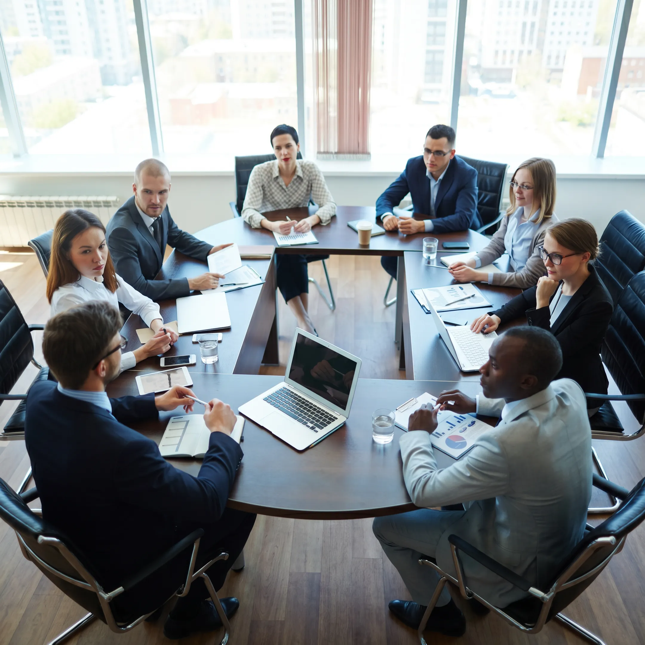 Consultants analyzing operational assessment data and manufacturing workflow charts.