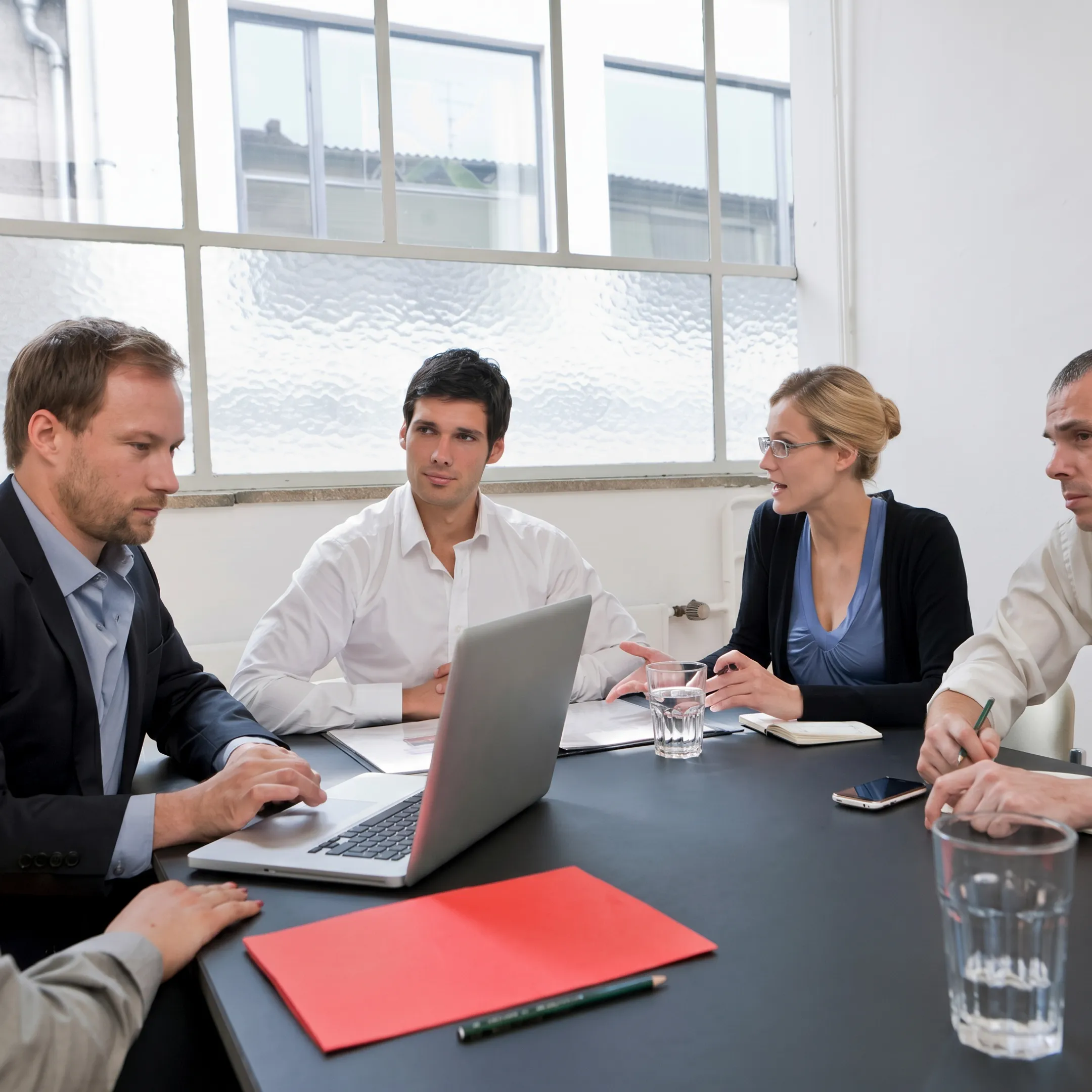 Operations advisory team collaborating on smart manufacturing workflow diagrams in a plant office