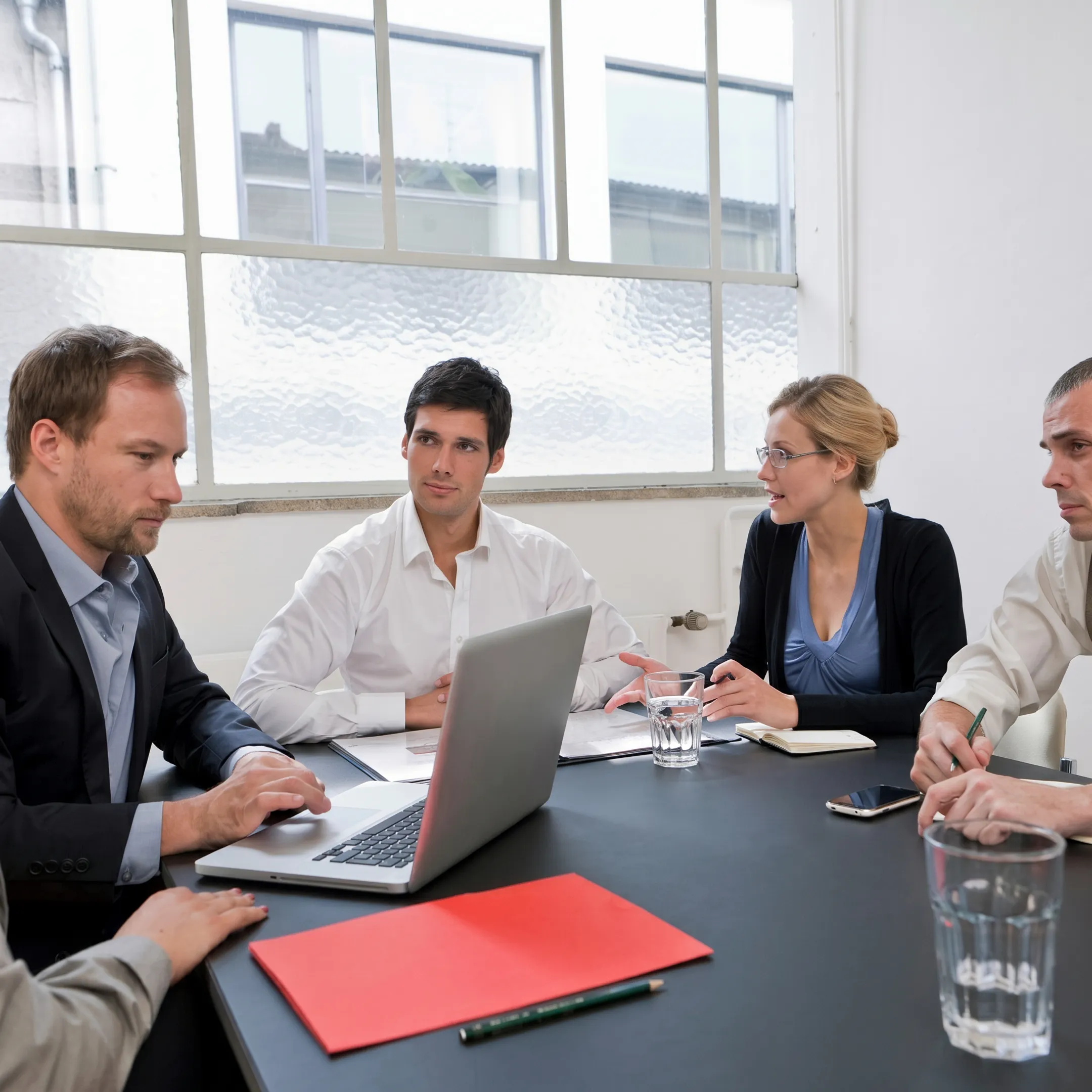 Consulting team analyzing lean value stream mapping diagrams on a whiteboard