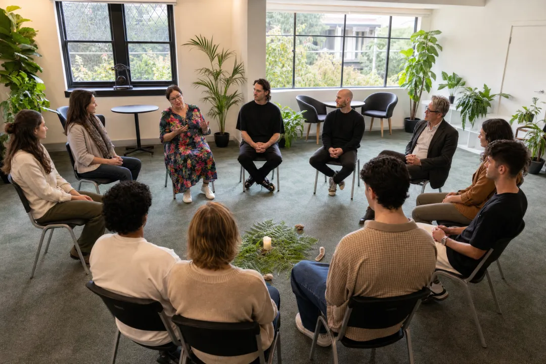 Group therapy workshop participants engaged in family constellation session