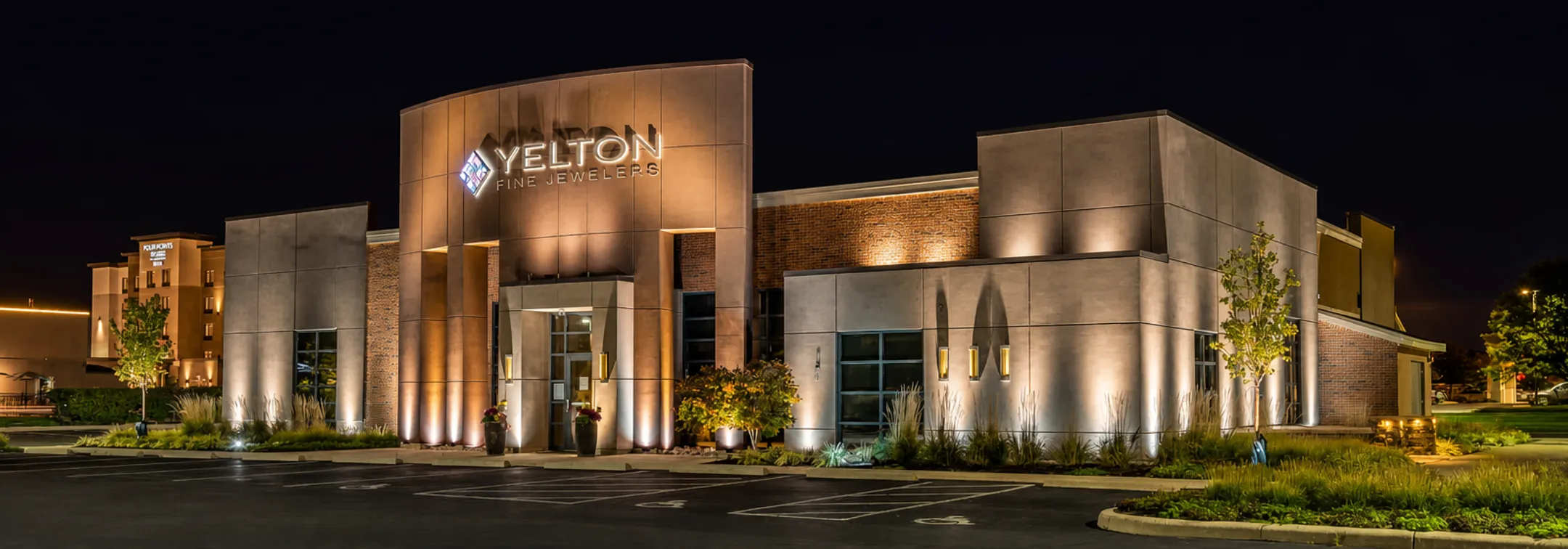 Illuminated restaurant storefront facade with lighting highlighting signage at night