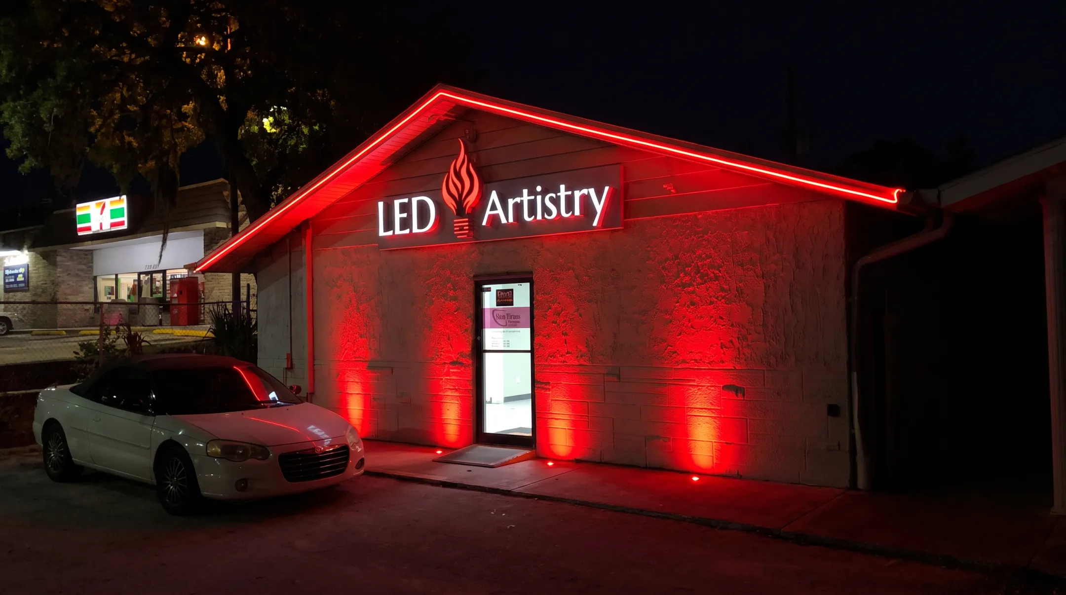 Commercial storefront illuminated with purple and red LED facade accent lighting