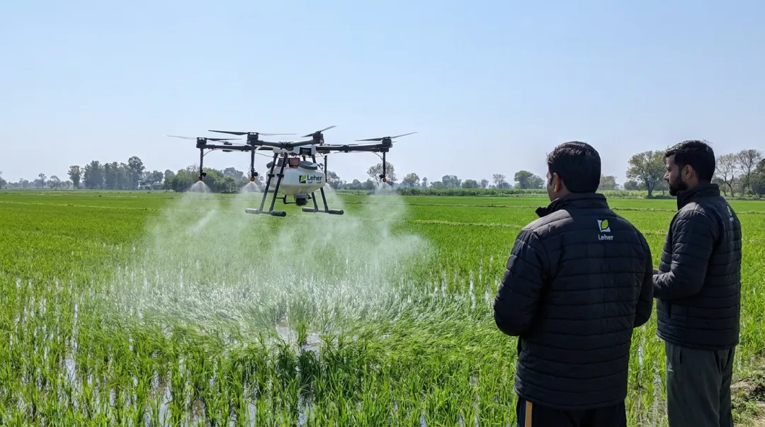 Leher drone spraying over paddy field showing precision low-volume application