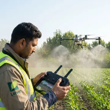 Agriculture drone spraying crops in a field