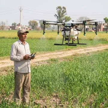Agriculture drone spraying an Indian crop field